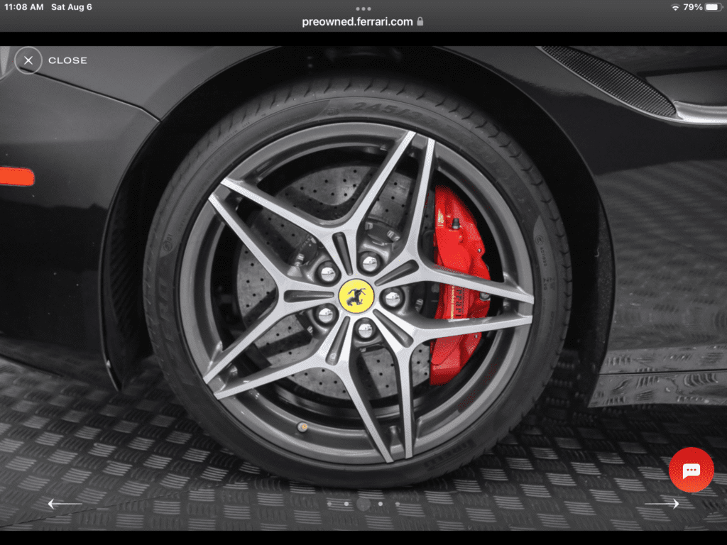 Ferrari wheel with red brake caliper.