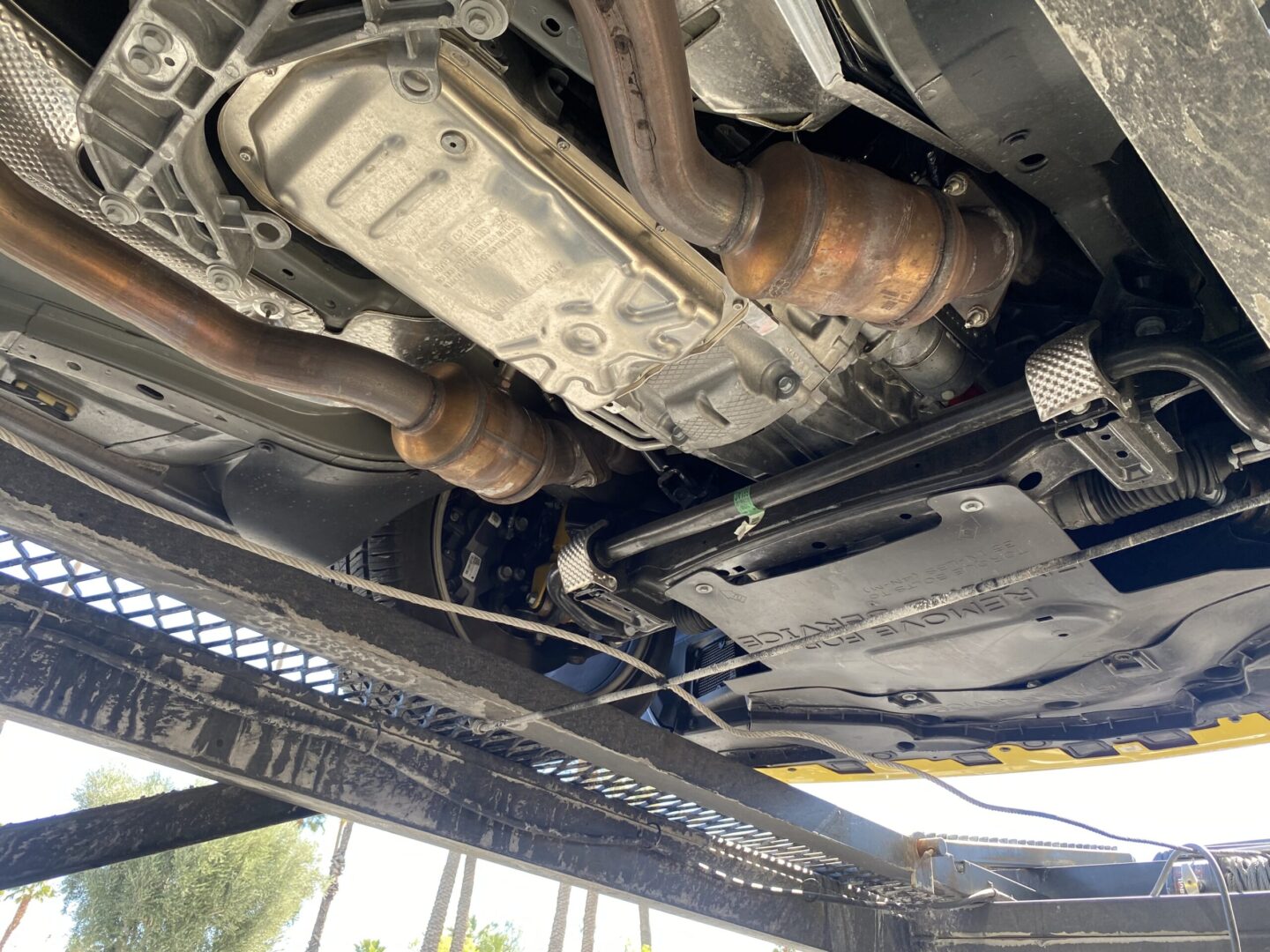Car undercarriage view with exhaust system.