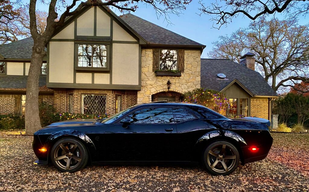 Black car parked in front of house.