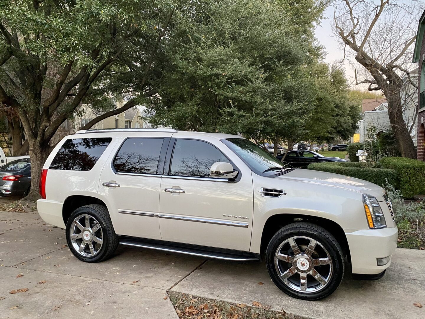 White SUV parked on suburban driveway.