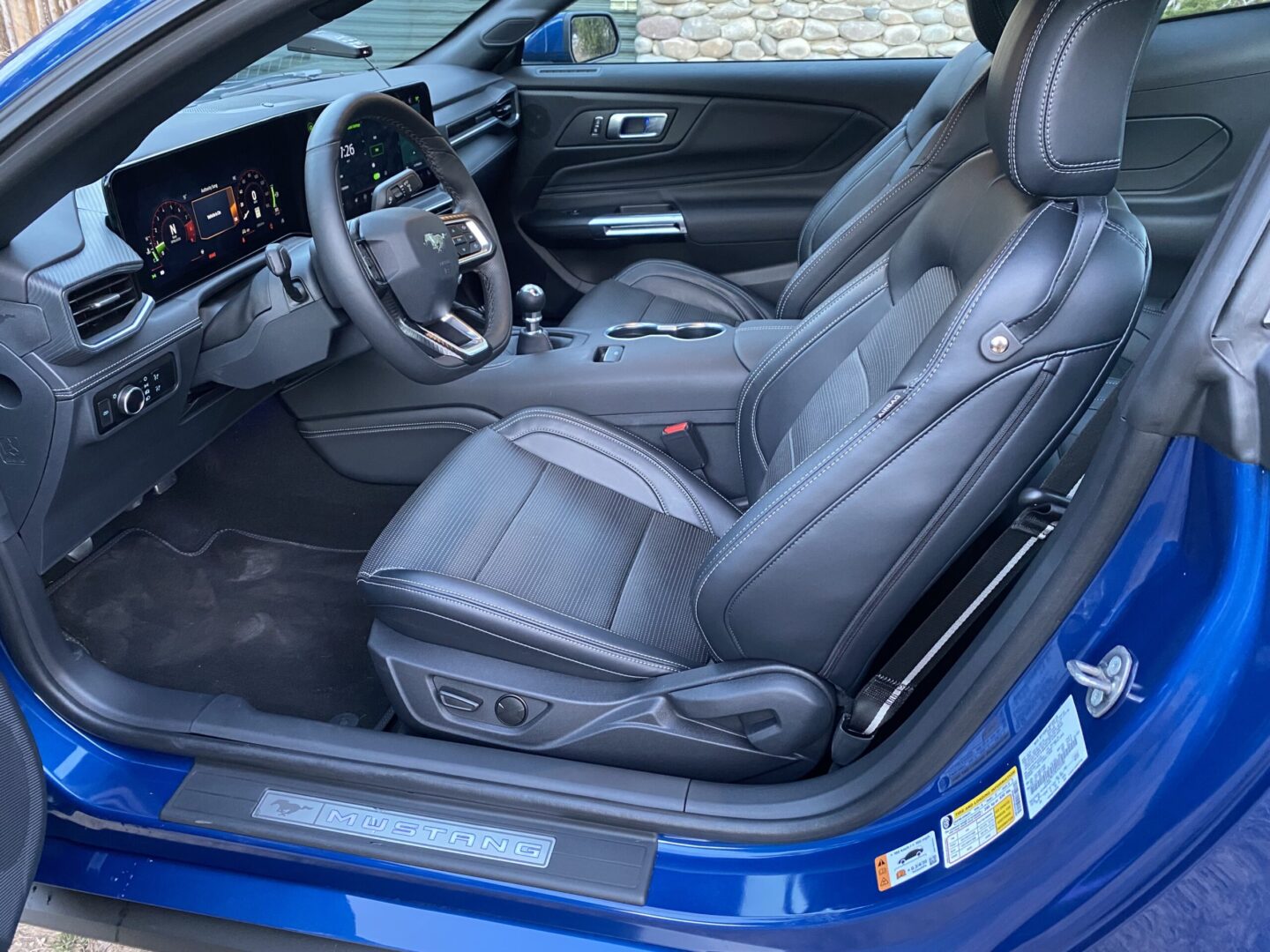 Blue car interior with black leather seats.