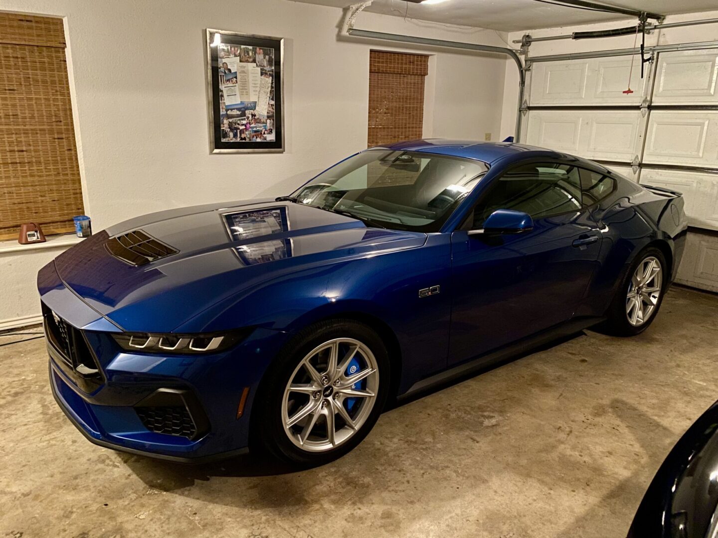 Blue sports car parked in a garage.