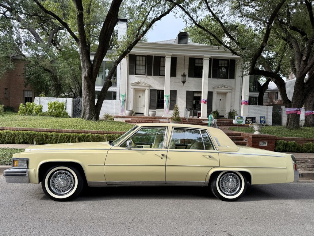 Vintage car parked in front of house.